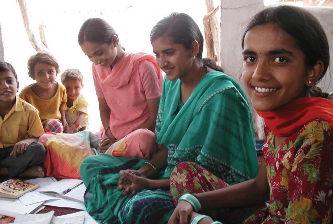 Young women seated looking at papers