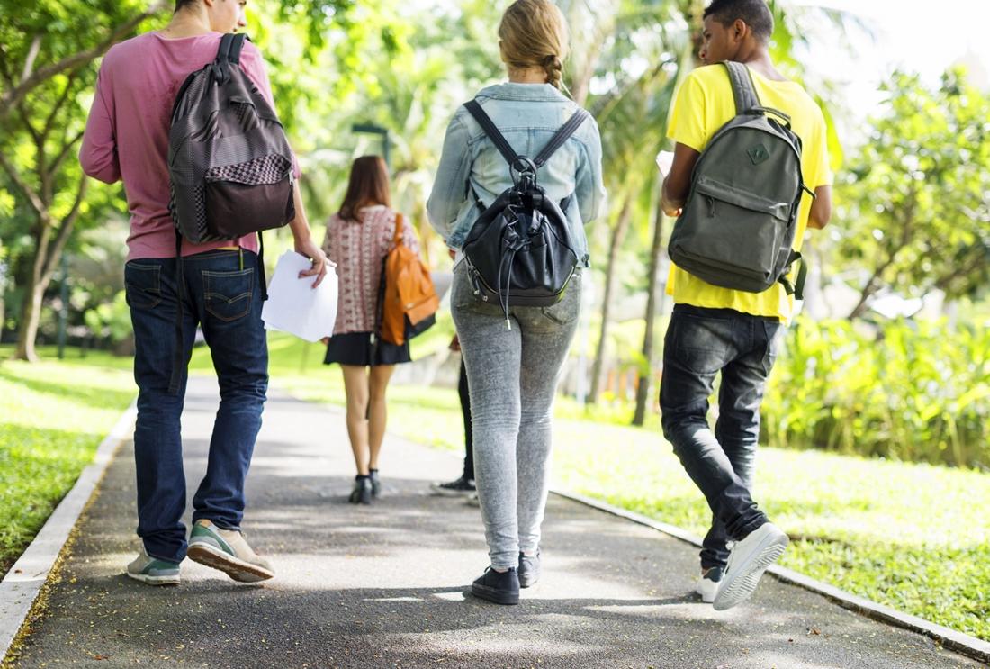 Three college students walking to class