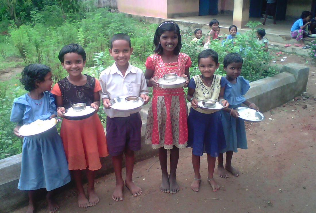 Schoolchildren in Orissa, India pose with their mid-day meals.