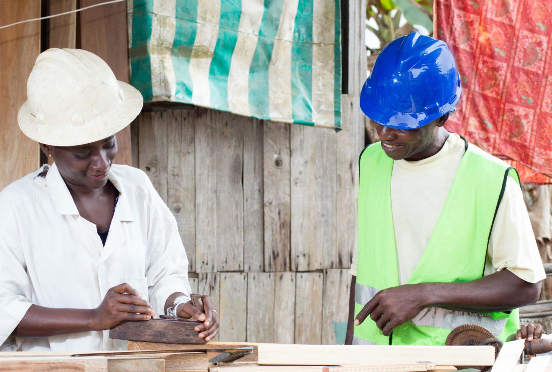 Two people in hard hats at work