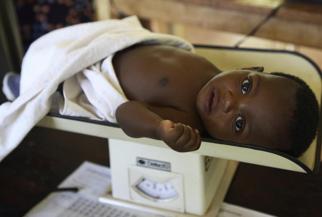 A baby is weighed in a health clinic.