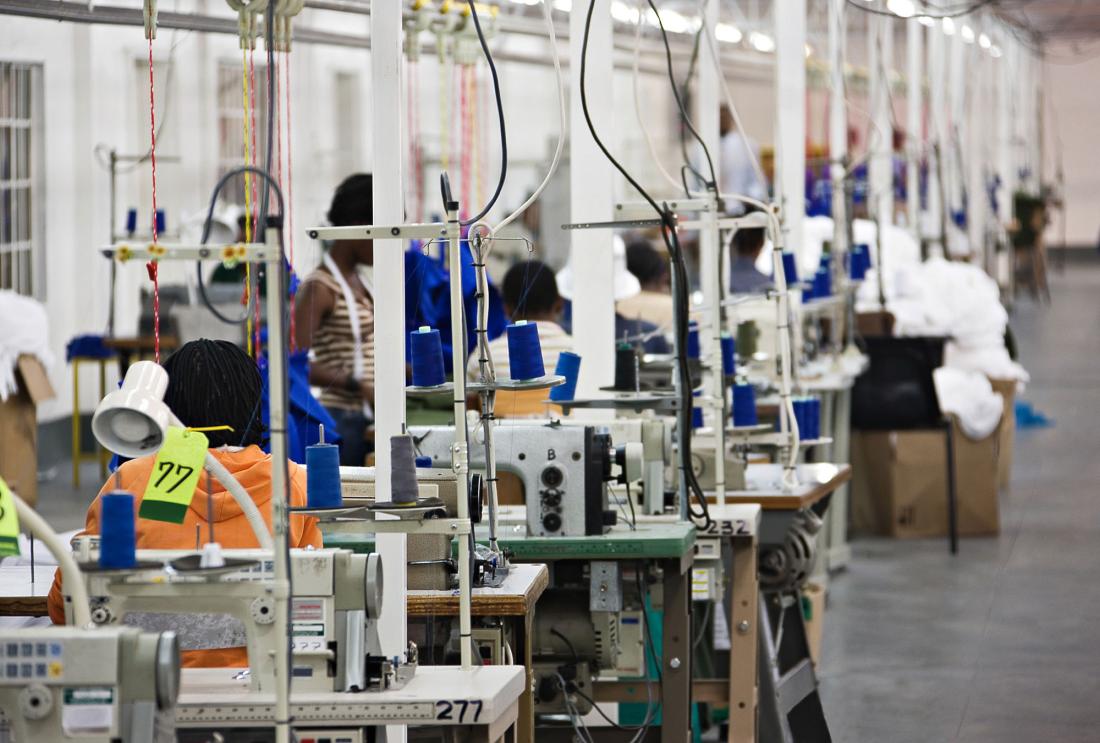 Rows of people working at industrial sewing machines