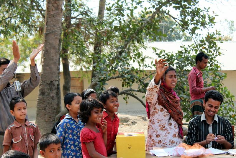 Man and woman lead demonstration as children look on