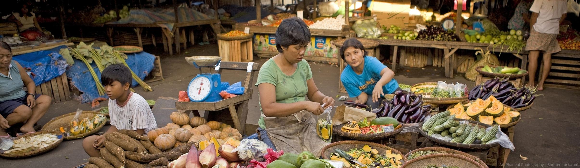 people at market selling fresh produce