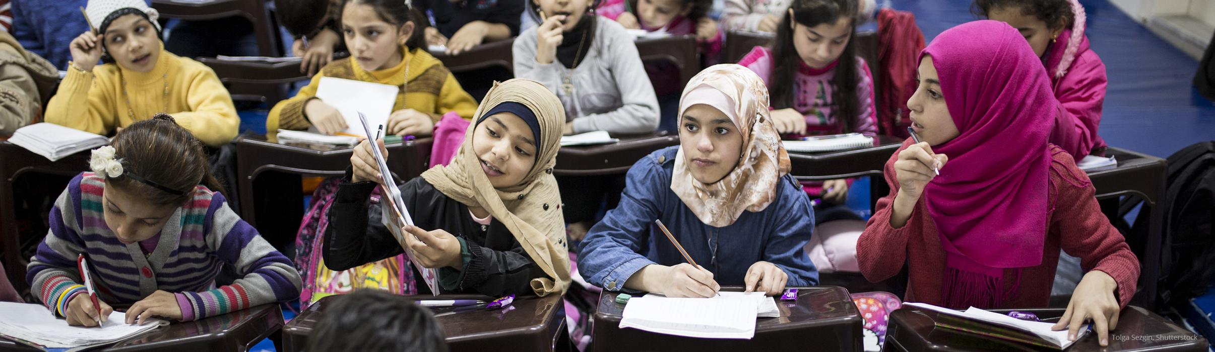 Syrian refugee children studying in a classroom in Istanbul, Turkey.