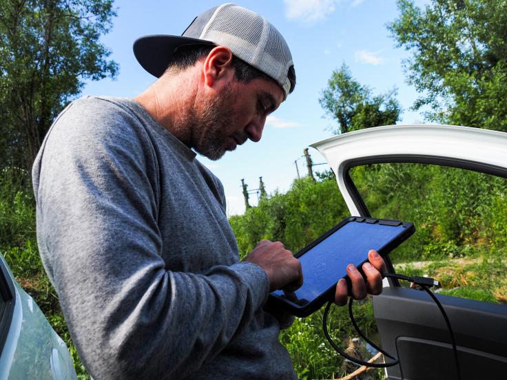 James inputs data into a tablet 