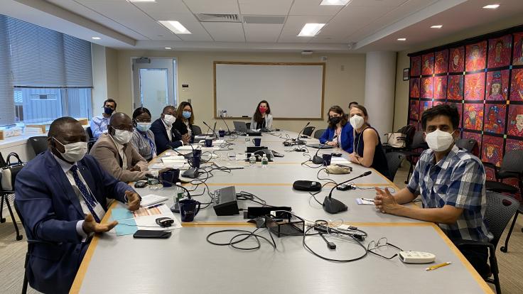 The Burkina Faso delegation and J-PAL staff sit around a conference table