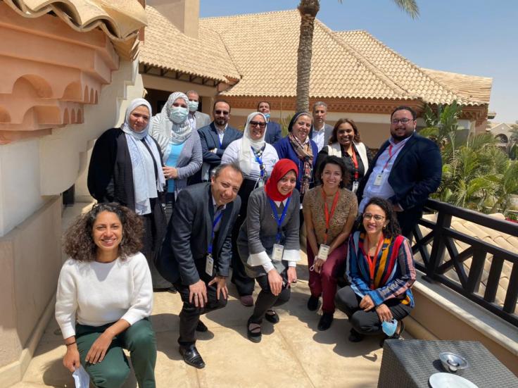 A group of staff pose for a photo outdoors in Cairo