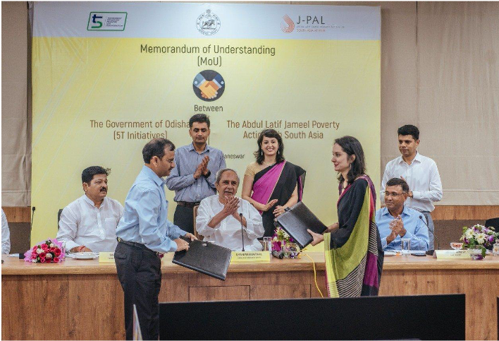 An official signing ceremony between J-PAL South Asia staff and government officials