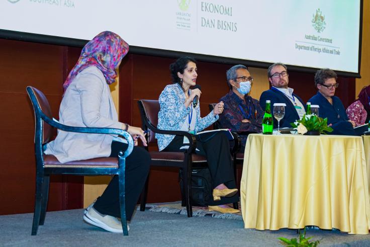 Four presenters sit on stage and present for J-PAL SEA's conference, Emerging Challenges in the Environment Landscape: Addressing Climate Change, Sustainability, and Poverty