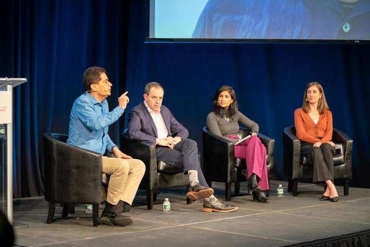 Four panelists on a stage