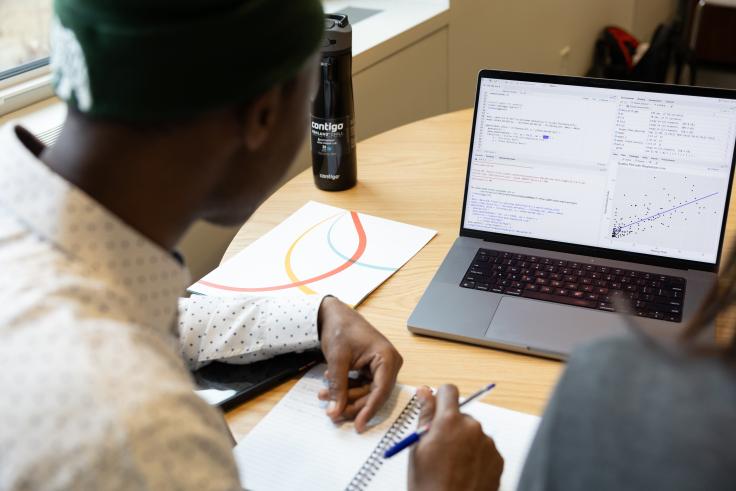 A DEDP MicroMasters student working on his laptop to complete an R module.