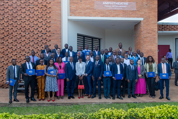 The first cohort of Ivorian civil servants to graduate from the joint program pose holding their certificates with J-PAL Europe staff and partners.
