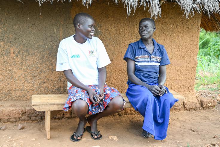 Two women sitting on a bench talking