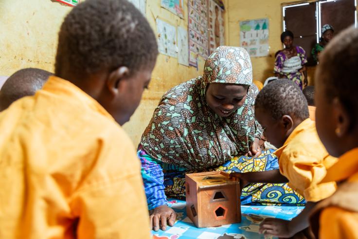 Children watching attentively as teacher teaches in Ghana, Africa
