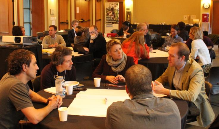 Participants in a workshop sitting around a table.