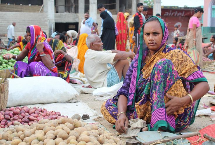 Woman sells potatoes in open market