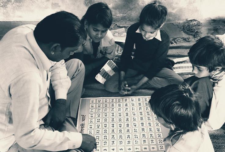 Children gather around to play a game