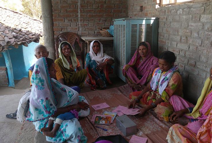 Women sit in a circle to have a meeting