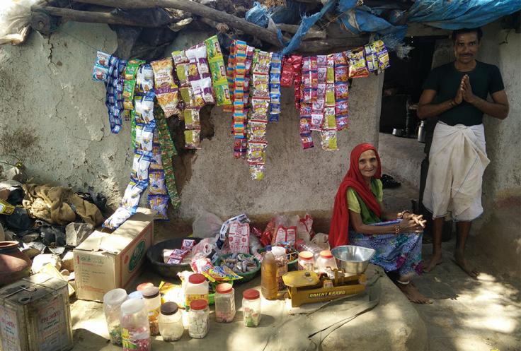 Woman and man sell snacks at outdoor stand