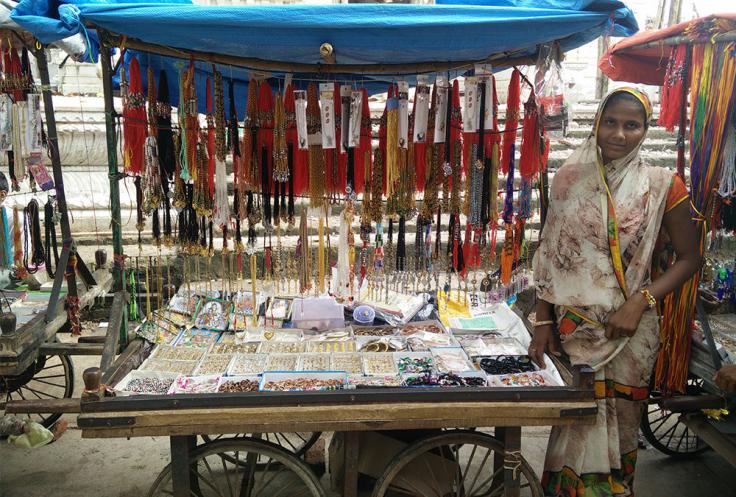 Woman sells jewelry in a roadside stand