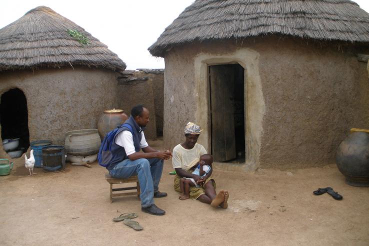 Savings client talks with surveyor in Ghana