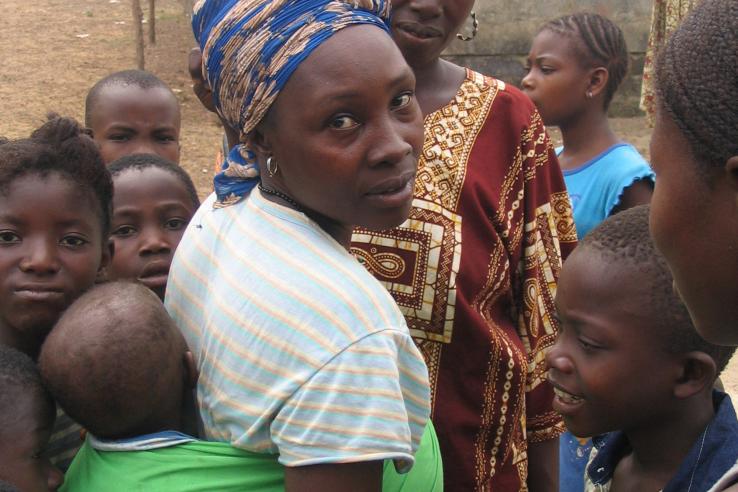 A woman carries her child