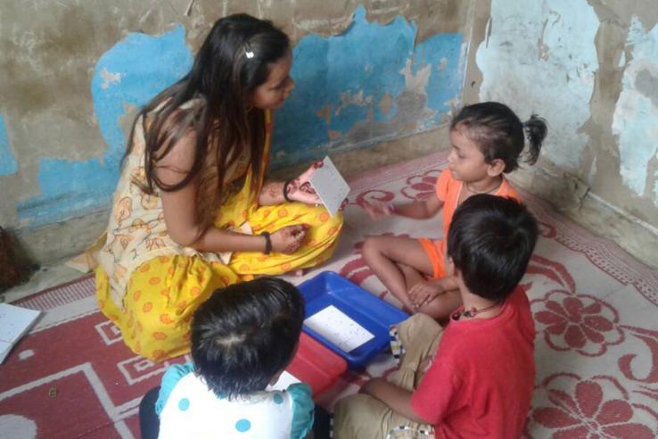 Woman plays educational games with children