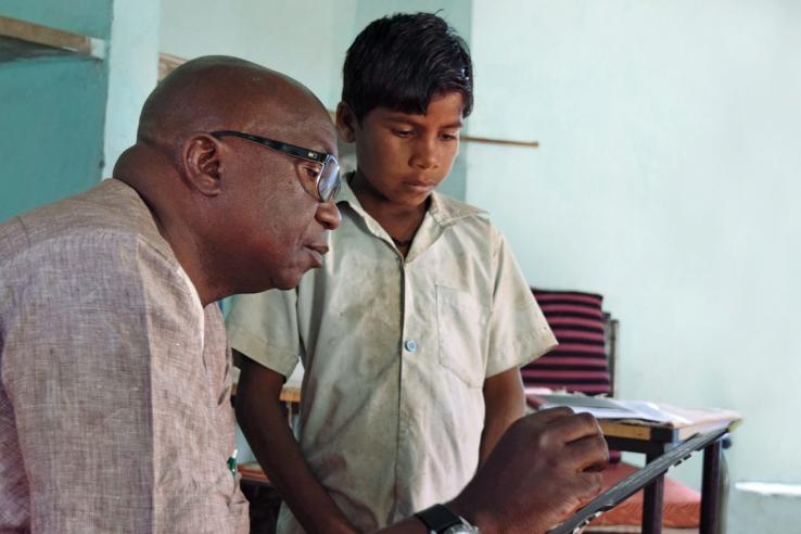 Man helps a child with schoolwork