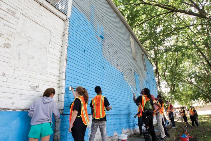 Youth painting a wall