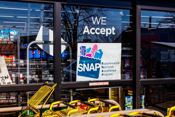 "We Accept SNAP" sign in store window 