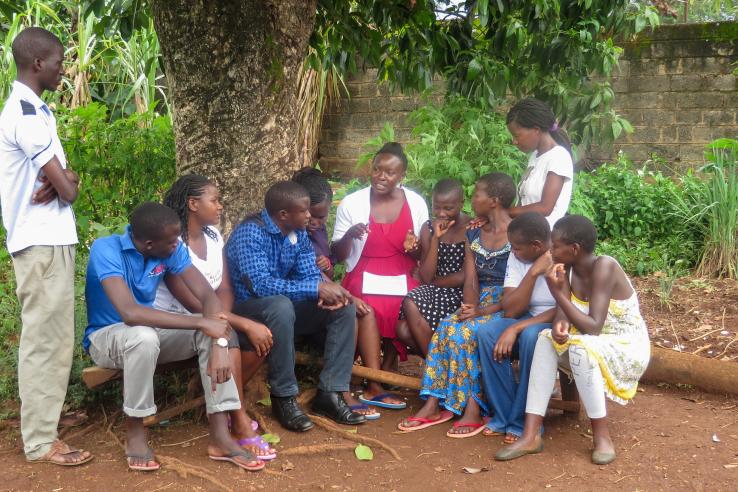 A Community Health Worker addresses a group of people in Kenya.