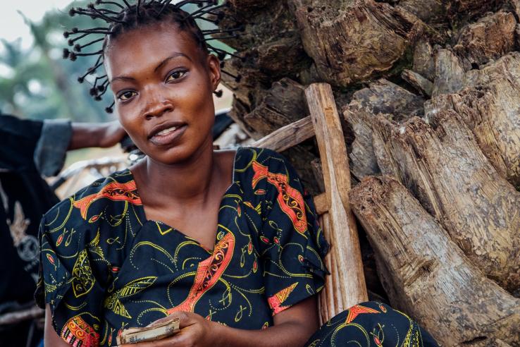 Young woman holding cash in DRC