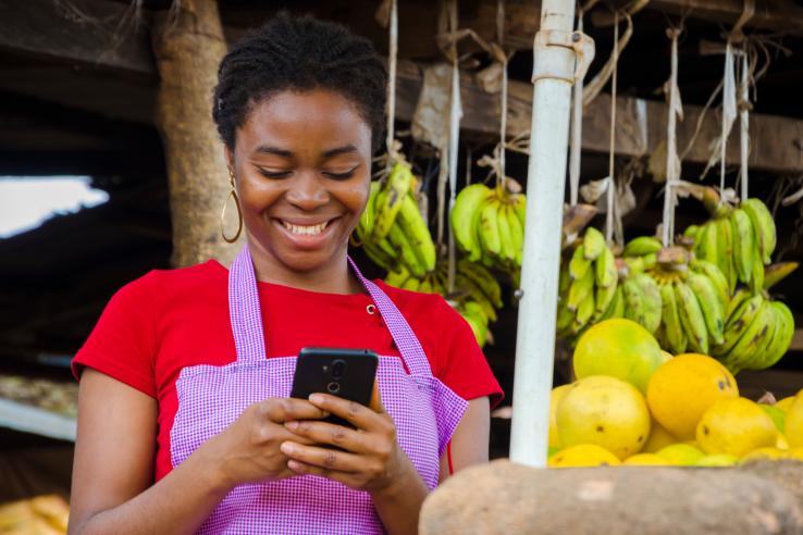 Women uses phone in market