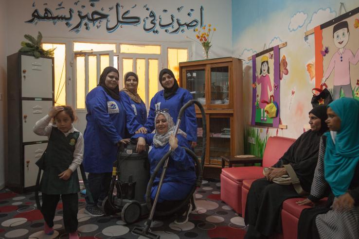 A group of female plumbers enter a school to fix a water tank in Jordan.