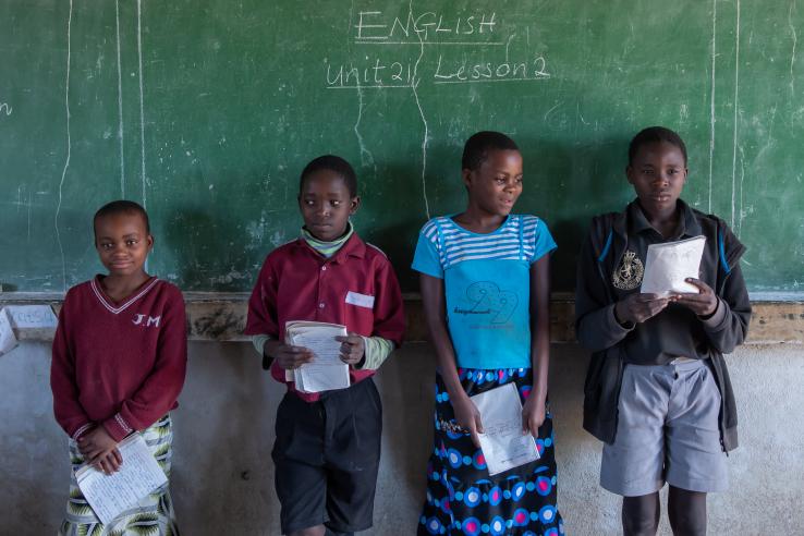 A group of students in front of a chalkboard