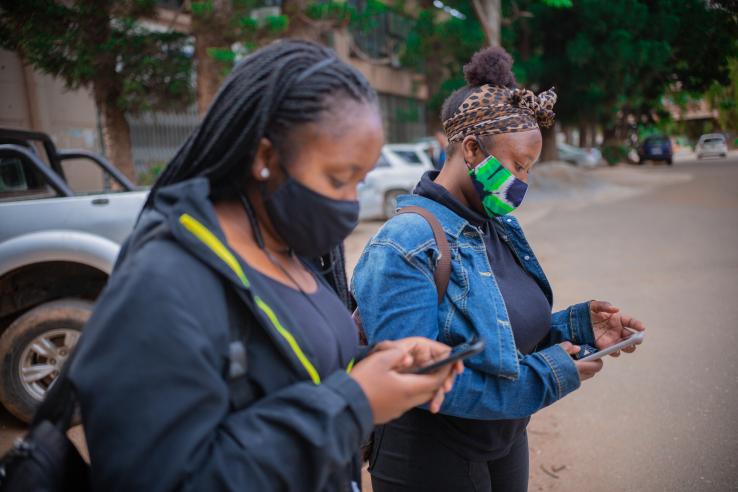 Girls receiving SMS messages about precautionary health measures.