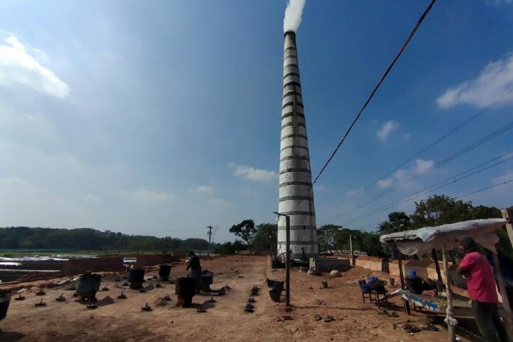 Smoke emitting from tall kiln chimney