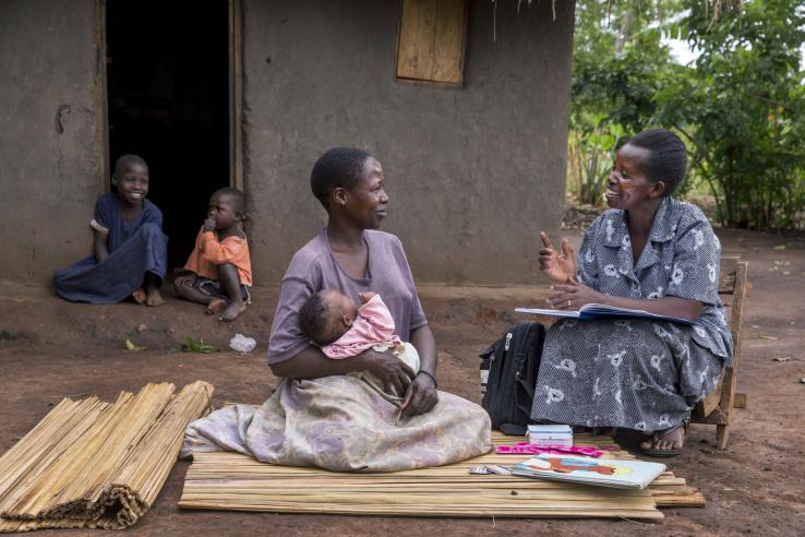 Women discusses with community health worker.