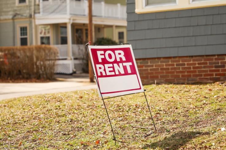 Red For Rent sign on lawn