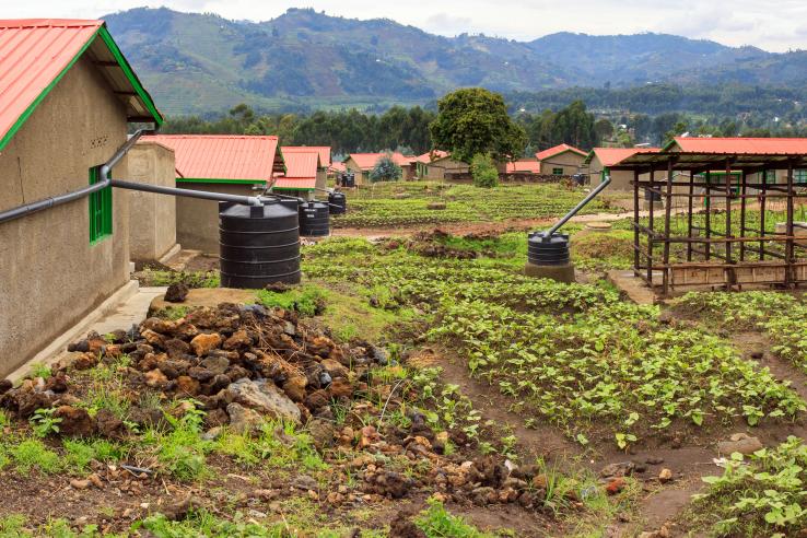 Water tanks attached to houses in a large field