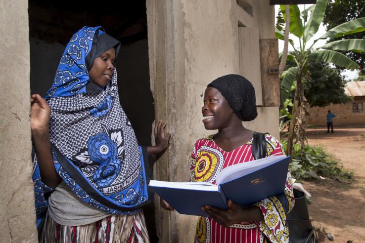 Women talking to each other in Uganda J-PAL Africa evaluation summary