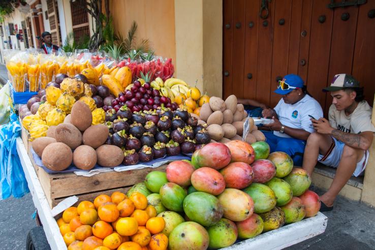 Fruit vendors staying connected to groups on their phones in Chile