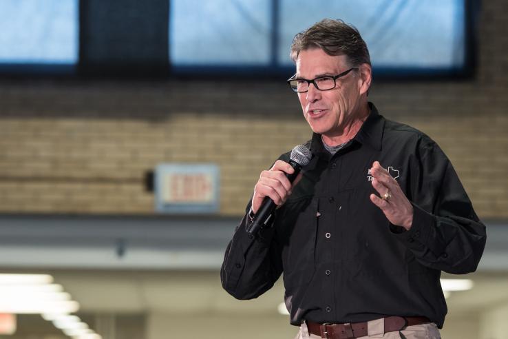 Televised campaign event with Rick Perry speaking into microphone in the United States