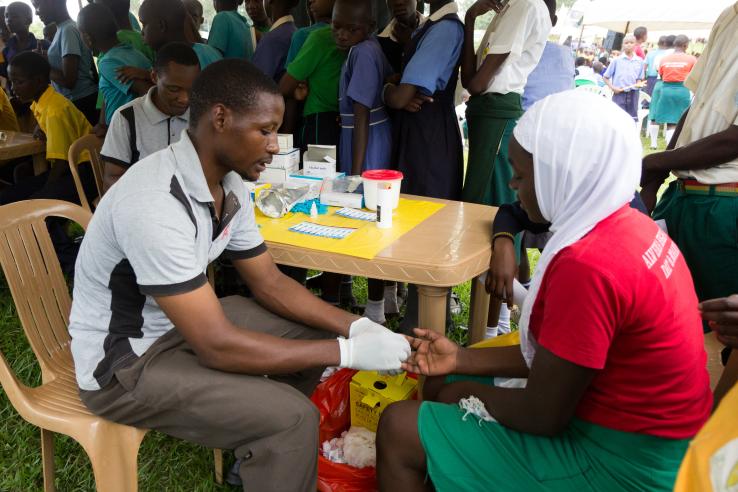 A girl receives voluntary counseling and testing (VCT) during a school-based health outreach event