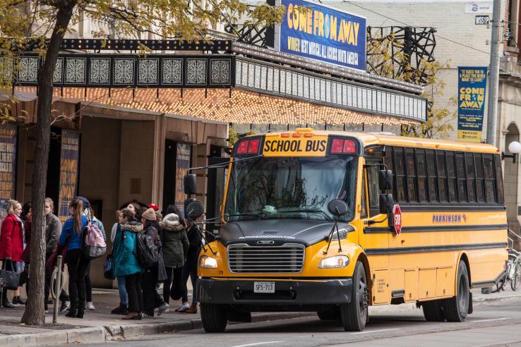 Student getting off bus in Canada