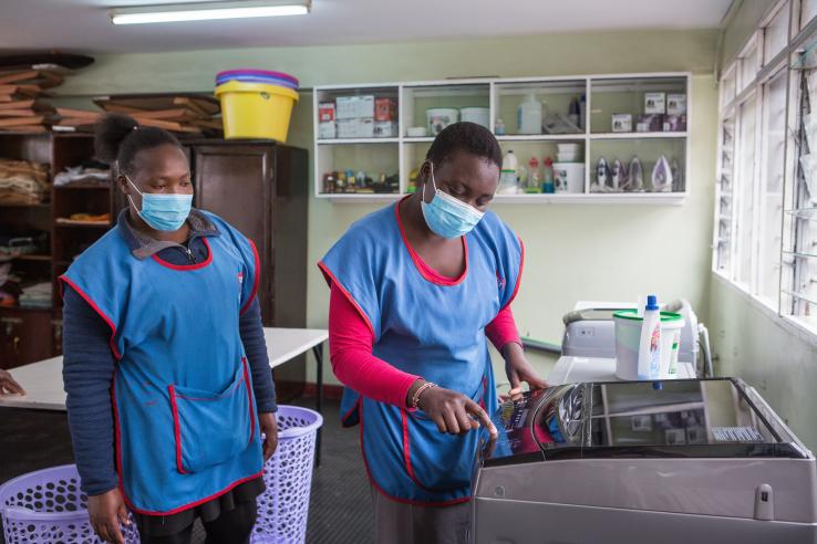 Two women working in a laundry room