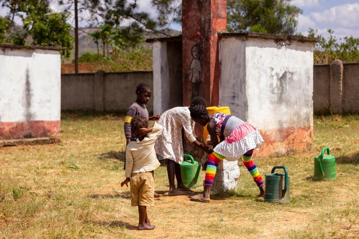 Group of children using sanitation service to wash hands in Senegal