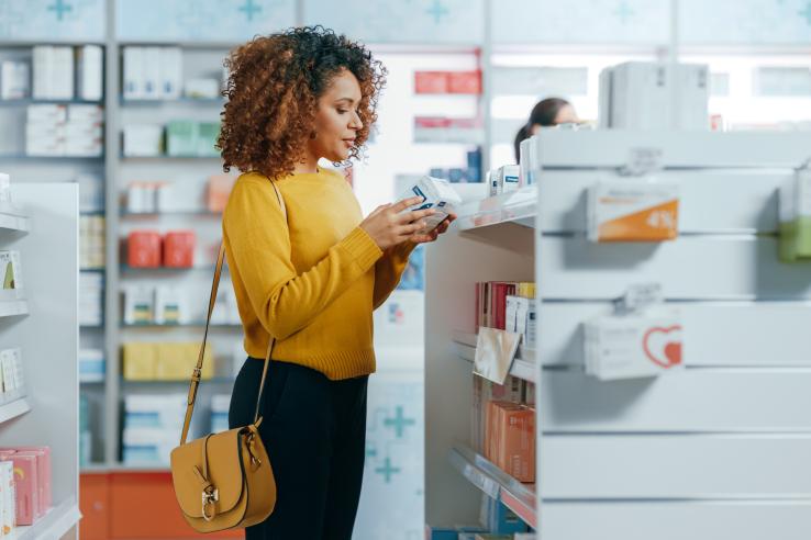 Woman looks at items in a pharmacy.