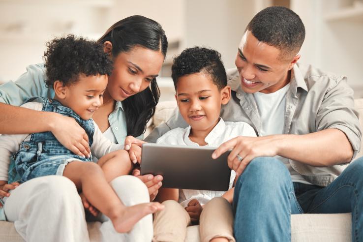 Parents and children engaging with educational program on tablet in the United States